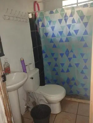 a bathroom with a toilet and a sink at Casa Jaragua in Barra de Santiago