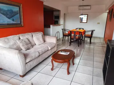 a living room with a couch and a table at Suites & Apartments San Benito - Zona Rosa in San Salvador