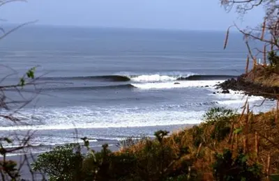 a view of a beach with waves in the ocean at Las Flores Resort in Chirilagua