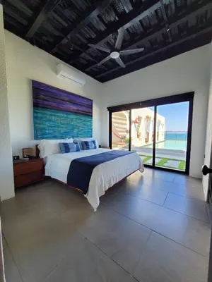a bedroom with a bed with a view of the ocean at CASA ROMA Hotel Boutique in El Tamarindo