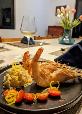 a plate of food with shrimp and vegetables on a table at CASA ROMA Hotel Boutique in El Tamarindo