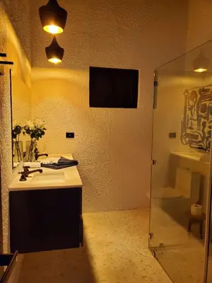 a bathroom with a sink and a mirror at CASA ROMA Hotel Boutique in El Tamarindo