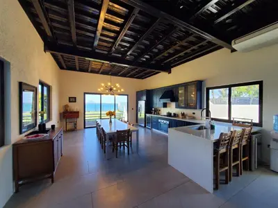 a large kitchen with a table and a dining room at CASA ROMA Hotel Boutique in El Tamarindo