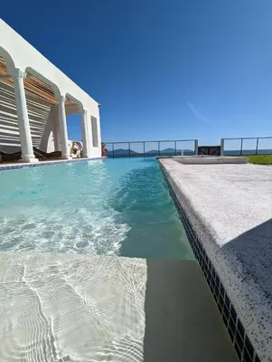 a swimming pool with the ocean in the background at CASA ROMA Hotel Boutique in El Tamarindo
