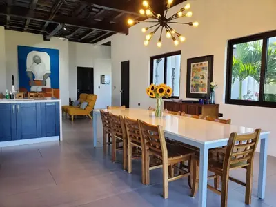 a dining room with a white table and chairs at CASA ROMA Hotel Boutique in El Tamarindo