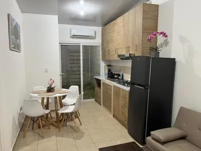 a kitchen with a black refrigerator and a table at Dream of angels home in Santa Ana