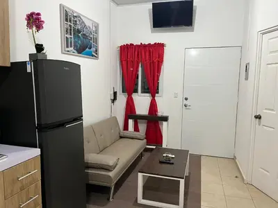 a living room with a couch and a refrigerator at Dream of angels home in Santa Ana