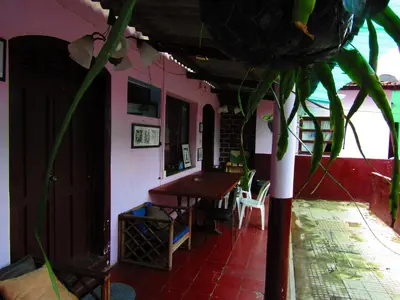 a house with a table and chairs in a room at Casa Vieja Guest House in Santa Ana