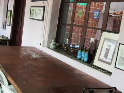 a table in a room with a window and some shoes at Casa Vieja Guest House in Santa Ana