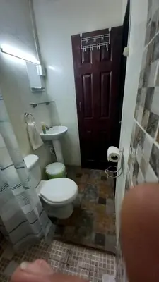 a bathroom with a toilet and a sink and a door at Casa Vieja Guest House in Santa Ana