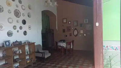 a living room with a table and plates on the wall at Casa Vieja Guest House in Santa Ana