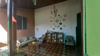 a living room with a couch and plates on the wall at Casa Vieja Guest House in Santa Ana