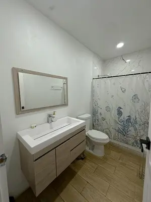 a bathroom with a sink and a toilet and a mirror at Casa Francisca in Alegría