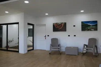 a waiting room with two chairs and paintings on the wall at Casa Francisca in Alegría