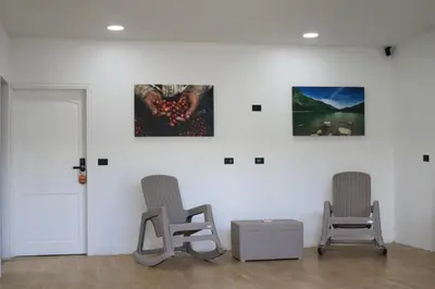 two chairs in a room with two paintings on the wall at Casa Francisca in Alegría