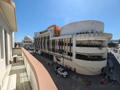 a building with a car parked in front of it at Hotel Abrego in San Salvador