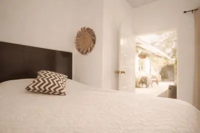 a bedroom with a bed with a pillow on it at Habitación Deluxe Tierra - Villa Valle Campo in Nahuizalco