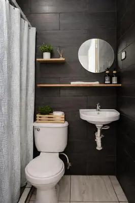 a bathroom with a white toilet and a sink at Habitación Deluxe Tierra - Villa Valle Campo in Nahuizalco