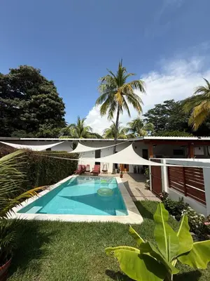 a swimming pool in the yard of a house at 1 Family Pool Villa BBQ PARKING EL SUNZAL Surf City Area in El Sunzal