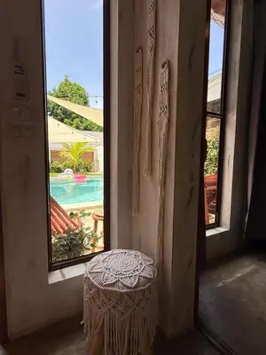 a small stool in a room with a window at 1 Family Pool Villa BBQ PARKING EL SUNZAL Surf City Area in El Sunzal