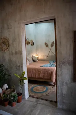 a mirror reflection of a bed in a bedroom at 3 Family Villa Private Pool Parking BBQ El Sunzal El Tunco El Zonte SURFCITY in Tamanique