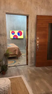 a room with a bed and a painting on the wall at 3 Family Villa Private Pool Parking BBQ El Sunzal El Tunco El Zonte SURFCITY in Tamanique