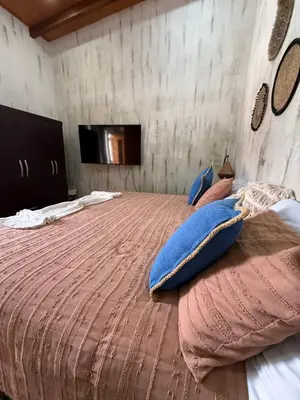 a bedroom with a large bed with pillows on it at 3 Family Villa Private Pool Parking BBQ El Sunzal El Tunco El Zonte SURFCITY in Tamanique