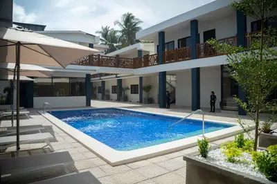 a swimming pool in front of a building at Hotel Mar Azul in Playa Negra