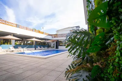 a resort with a swimming pool and a building at Hotel Mar Azul in Playa Negra