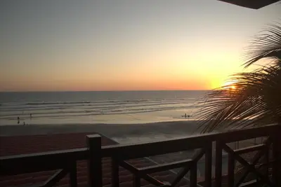 a sunset from the balcony of a beach at Hotel Mar Azul in Playa Negra