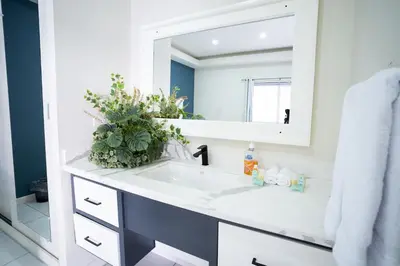 a bathroom with a white sink and a mirror at Hotel Mar Azul in Playa Negra
