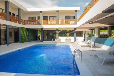 a swimming pool in front of a building at Hotel Mar Azul in Playa Negra