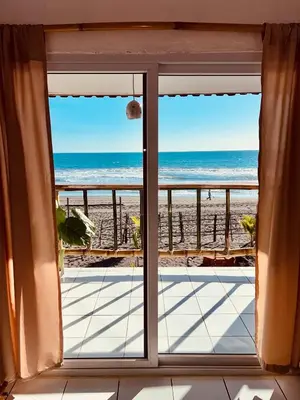 a view of the beach from a window at Surf House Mizata in Santa María Mizata