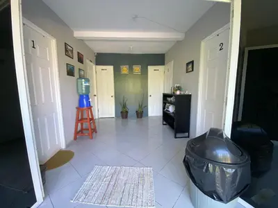 a hallway with a room with a door and a stool at Habitación cerca del aeropuerto #1 in Tilapa