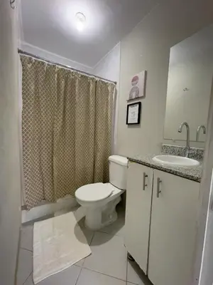 a white bathroom with a toilet and a sink at Habitación cerca del aeropuerto #1 in Tilapa