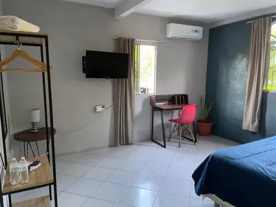 a bedroom with a bed and a table with a chair at Habitación cerca del aeropuerto #2 in La Paz
