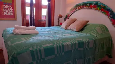 a bedroom with a bed with two pillows on it at Hostal Santa Clara B&B in Apaneca