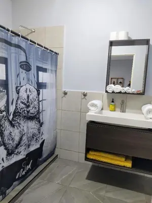 a bathroom with a bear shower curtain and a sink at Rancho Del Oso Tuerto in Marcelino