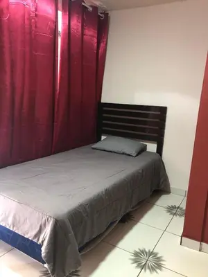 a bedroom with a bed with red drapes at Comfort Home Escalón in San Salvador