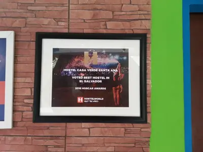 a picture of a poster on a brick wall at Hostal Casa Verde in Santa Ana