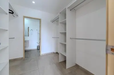 a room with white walls and a hallway with shelves at Margo 306- Luxe, Elegant & Cozy Condo- City Center in San Salvador