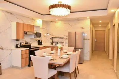 a kitchen and dining room with a table and chairs at Margo 306- Luxe, Elegant & Cozy Condo- City Center in San Salvador