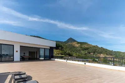 a roof deck with a view of a mountain at Margo 306- Luxe, Elegant & Cozy Condo- City Center in San Salvador