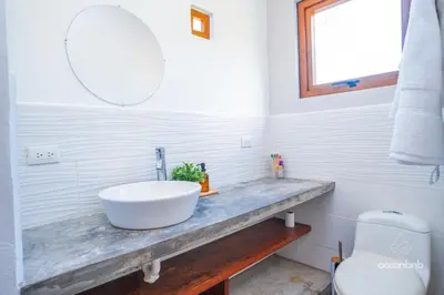 a bathroom with a sink and a toilet at SantiChanti Walk to Sunzal Beach in Tamanique