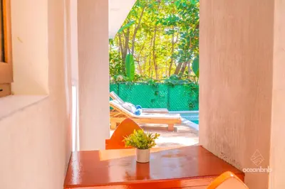 a dining room table with a view of a patio at SantiChanti Walk to Sunzal Beach in Tamanique