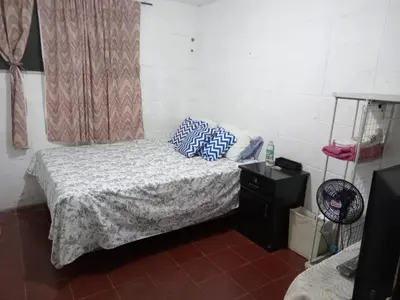 a bedroom with a bed with blue pillows on it at Santa Tecla Acogedora Guest House in Nueva San Salvador