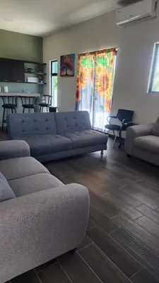 a living room with two couches and a kitchen at Casa Zelaya en Isla San Blas, La libertad salvador in La Libertad