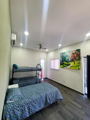 a bedroom with a bed and a painting on the wall at Casa Zelaya en Isla San Blas, La libertad salvador in La Libertad