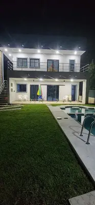 a large house with a swimming pool at night at Casa Zelaya en Isla San Blas, La libertad salvador in La Libertad