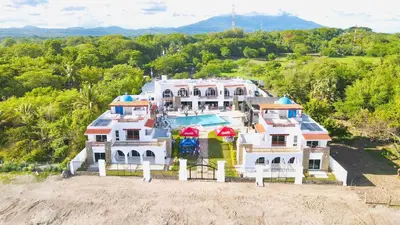a large white house with a swimming pool at Mariposa Reina B in El Jagüey